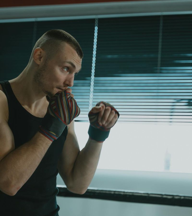 Man in a focused stance preparing for a strength exercise.